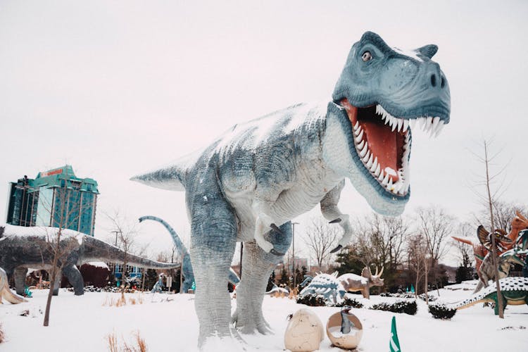 Giant Dinosaur Statue On Snow Covered Ground