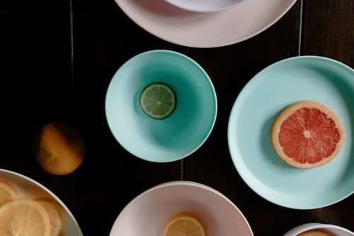 Free Top view of fresh exotic cut fruits including grapefruit lime and lemon in dishes Stock Photo