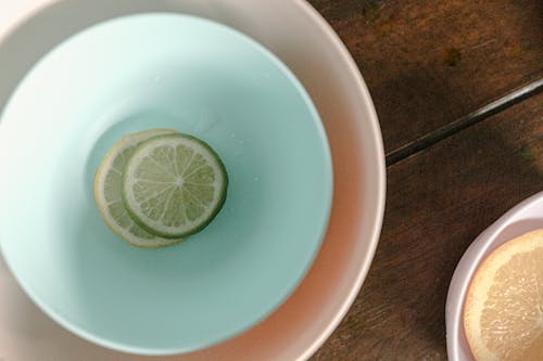 Bowls with sliced lemon and lime