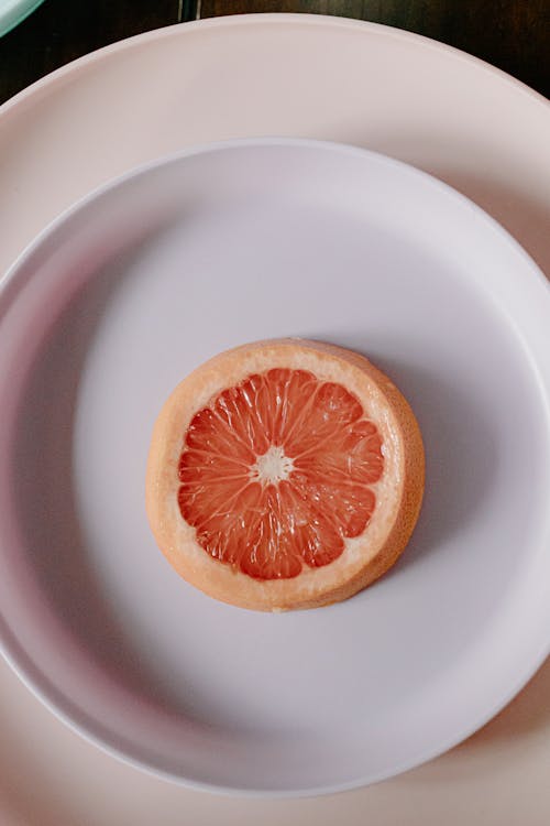 Plate with slice of fresh juicy grapefruit