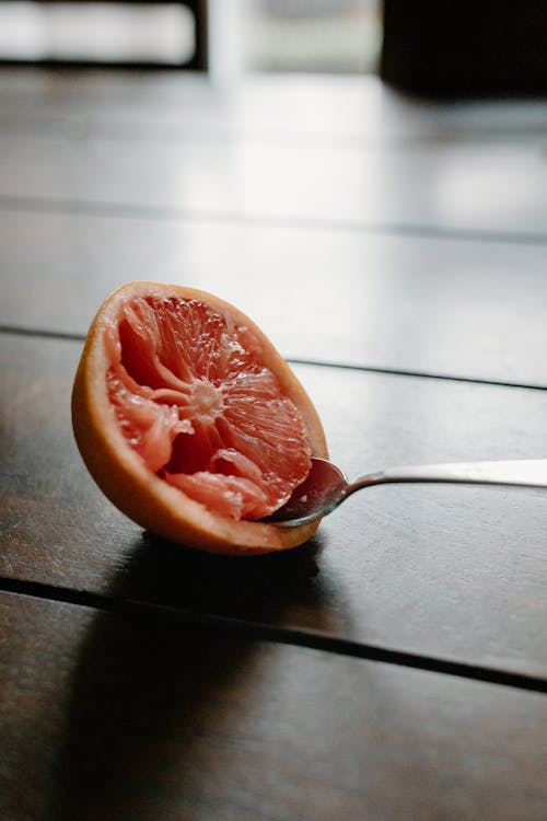 Half of juicy grapefruit with spoon