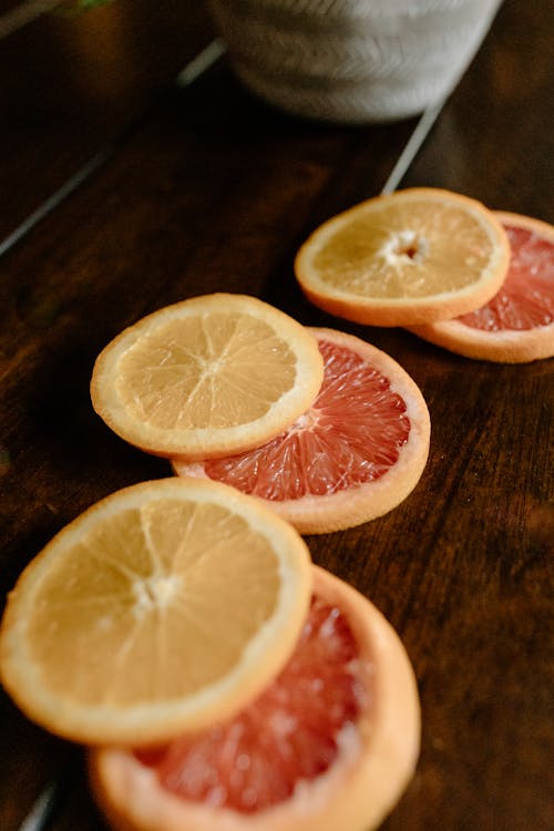 Sliced citrus fruits on wooden table