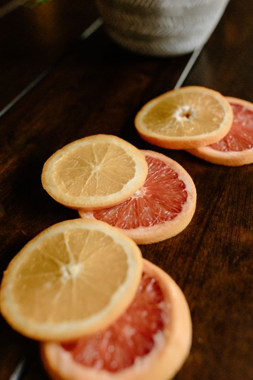 Free High angle of appetizing healthy tropical cut grapefruit and lemon on wooden table Stock Photo
