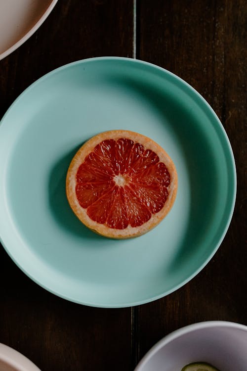 Top view of fresh delicious healthy breakfast with grapefruit placed on plate on table