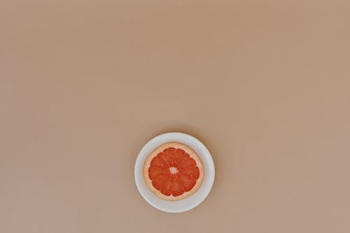 Sliced Grapefruit on White Ceramic Plate