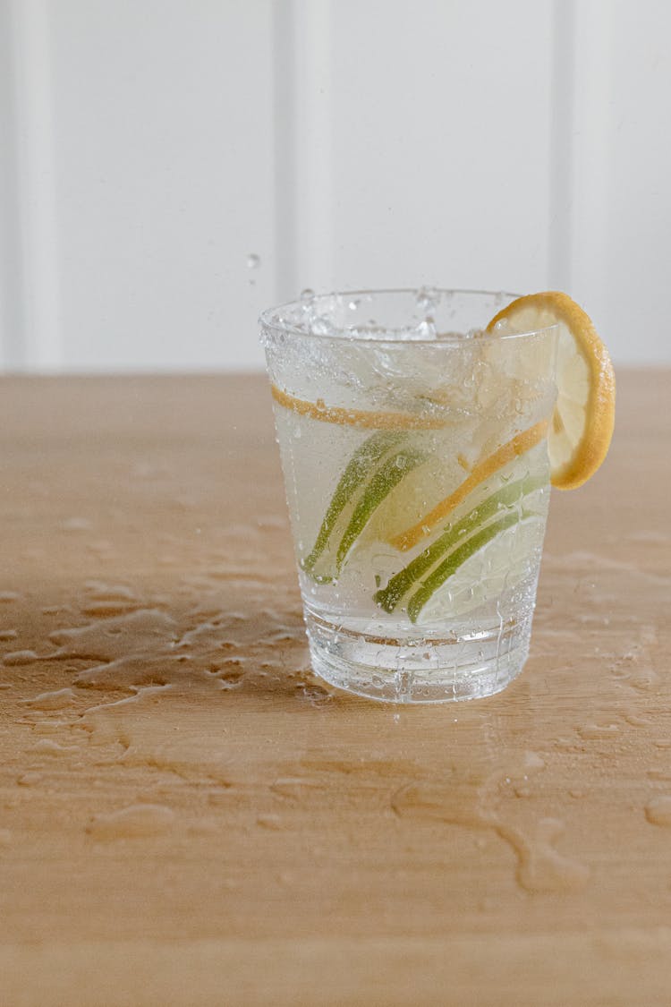 Clear Drinking Glass Of Water With Lemon And Lime Slices