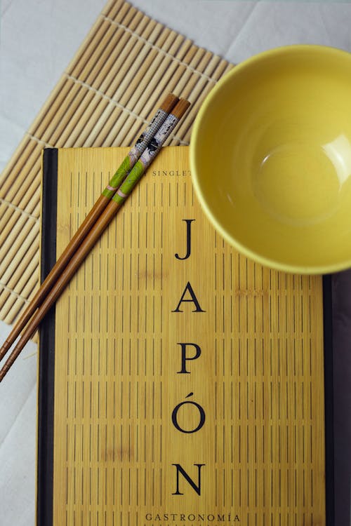 Free Ceramic Bowl on a Japanese Cookbook  Stock Photo