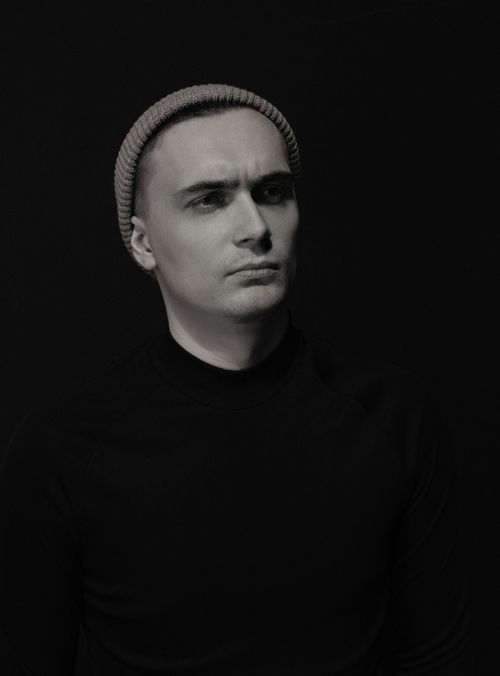 Free Stylish monochrome portrait of a man wearing a beanie against a black background. Stock Photo