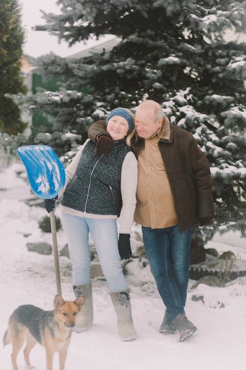 Man and Woman Standing on a Snow Covered Ground