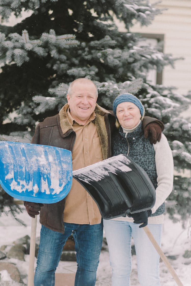 An Elderly Couple Holding Shovel