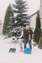 Elderly Couple Shoveling Snow Together