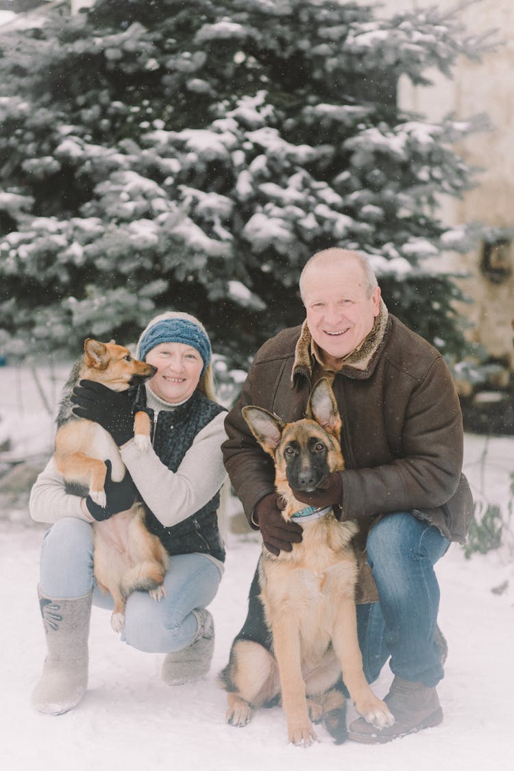 Man And Woman With Their Dogs