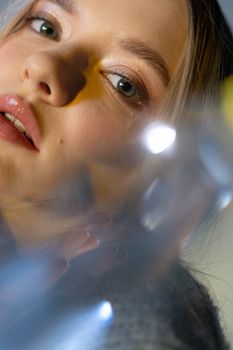 A close-up portrait of a woman with prism effects creating an artistic refraction illusion.