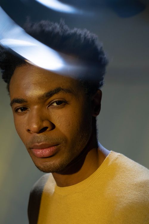 Free Portrait of a man with artistic prism light effects in a studio setting. Stock Photo