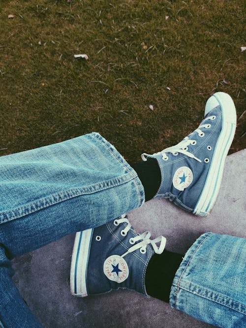 Free A Person Wearing Converse All Star Sneakers Stock Photo