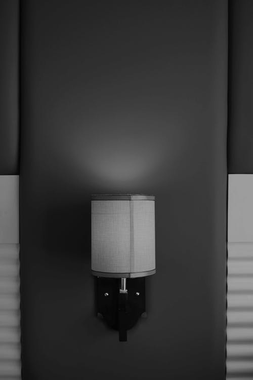 Grayscale Photo of a Wall Lamp