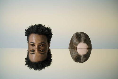 Free Artistic mirror portrait showing two heads with creative reflections, combining abstract elements and human interaction. Stock Photo