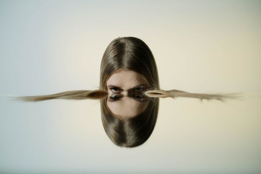 A conceptual portrait of a woman's reflection in water, offering tranquil and artistic vibes.