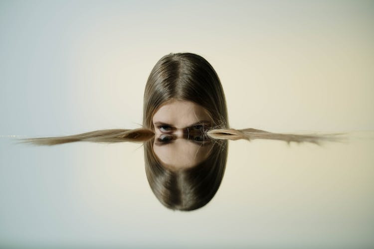 A Person Near A Mirror Reflection