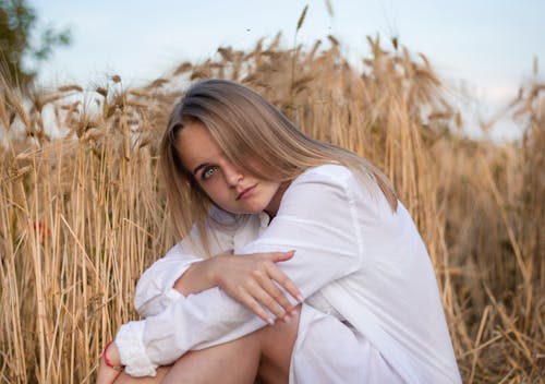 Woman Sitting Beside Wheat Grass