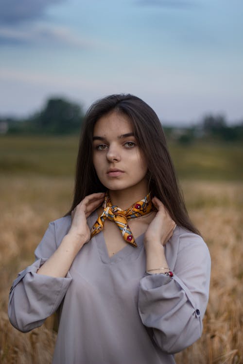 Woman Wearing a Scarf on Her Neck