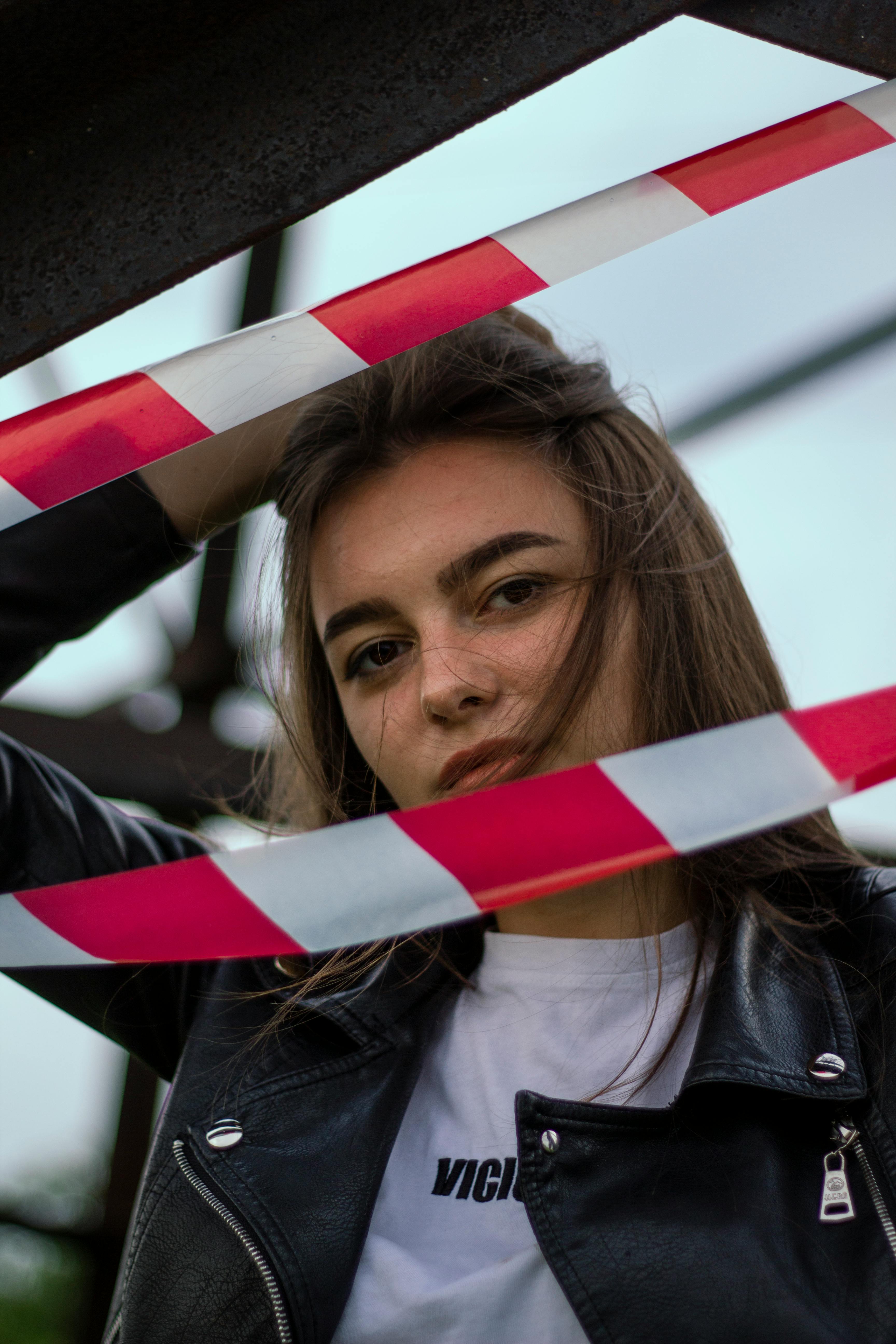 woman behind a red and white ribbon