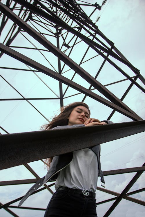 Woman Standing on the Transmission Tower