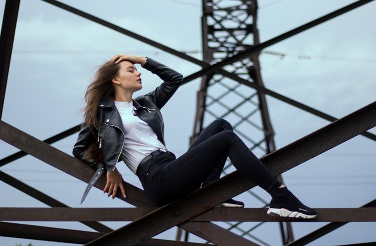 Woman Sitting On Steel Trusses