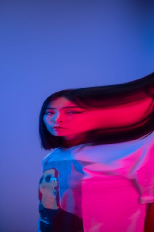 A Distorted Photo of a Short Haired Woman in White Shirt