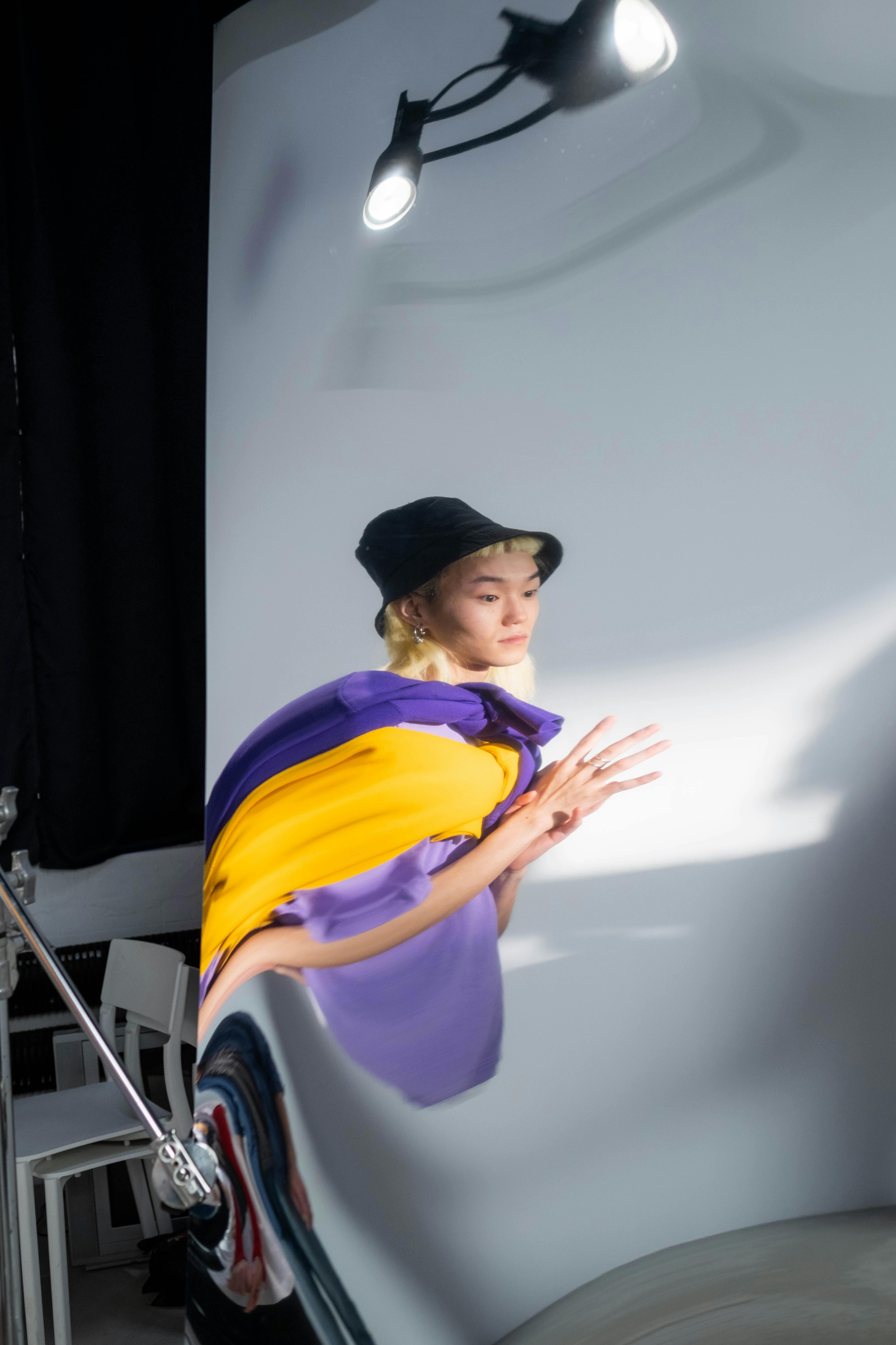 man in black hat and purple shirt