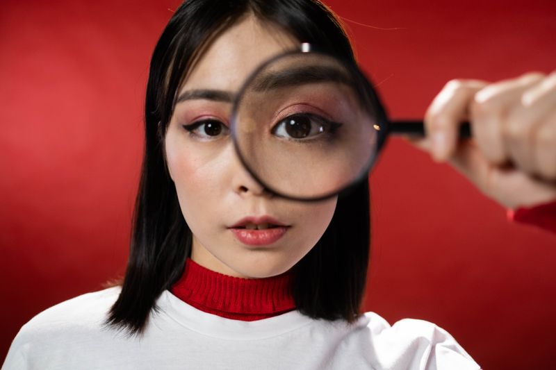 Studying an image in close detail through a magnifying glass