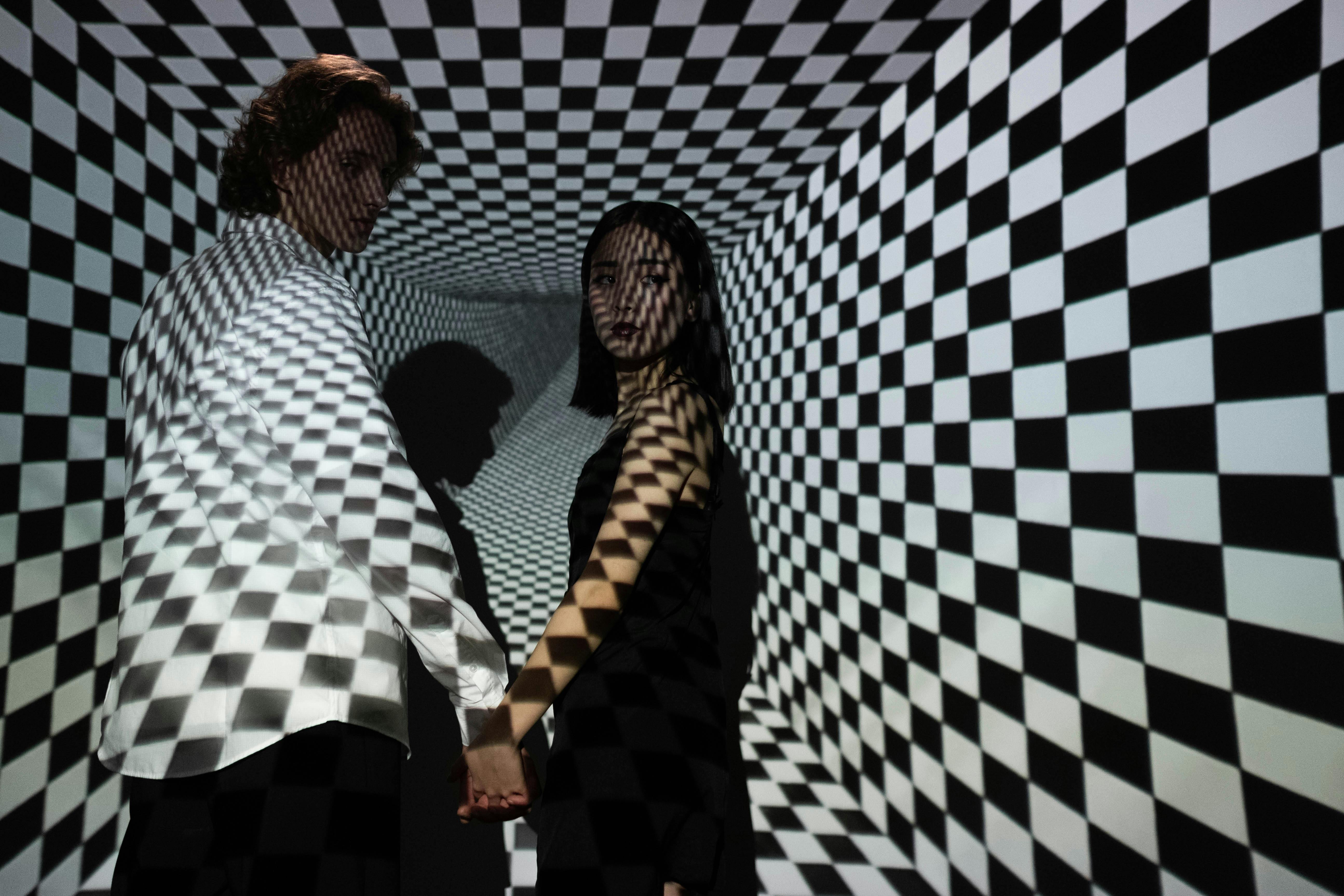 man and woman standing beside blue and white wall