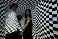 Man and Woman Standing Beside Blue and White Wall