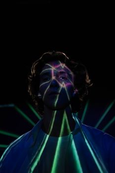 Photo by cottonbro studio Moody portrait of a young man with colorful light projections on his face.