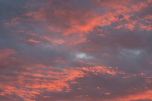 Free A stunning cloudscape at sunrise featuring vibrant pink and orange clouds. Stock Photo