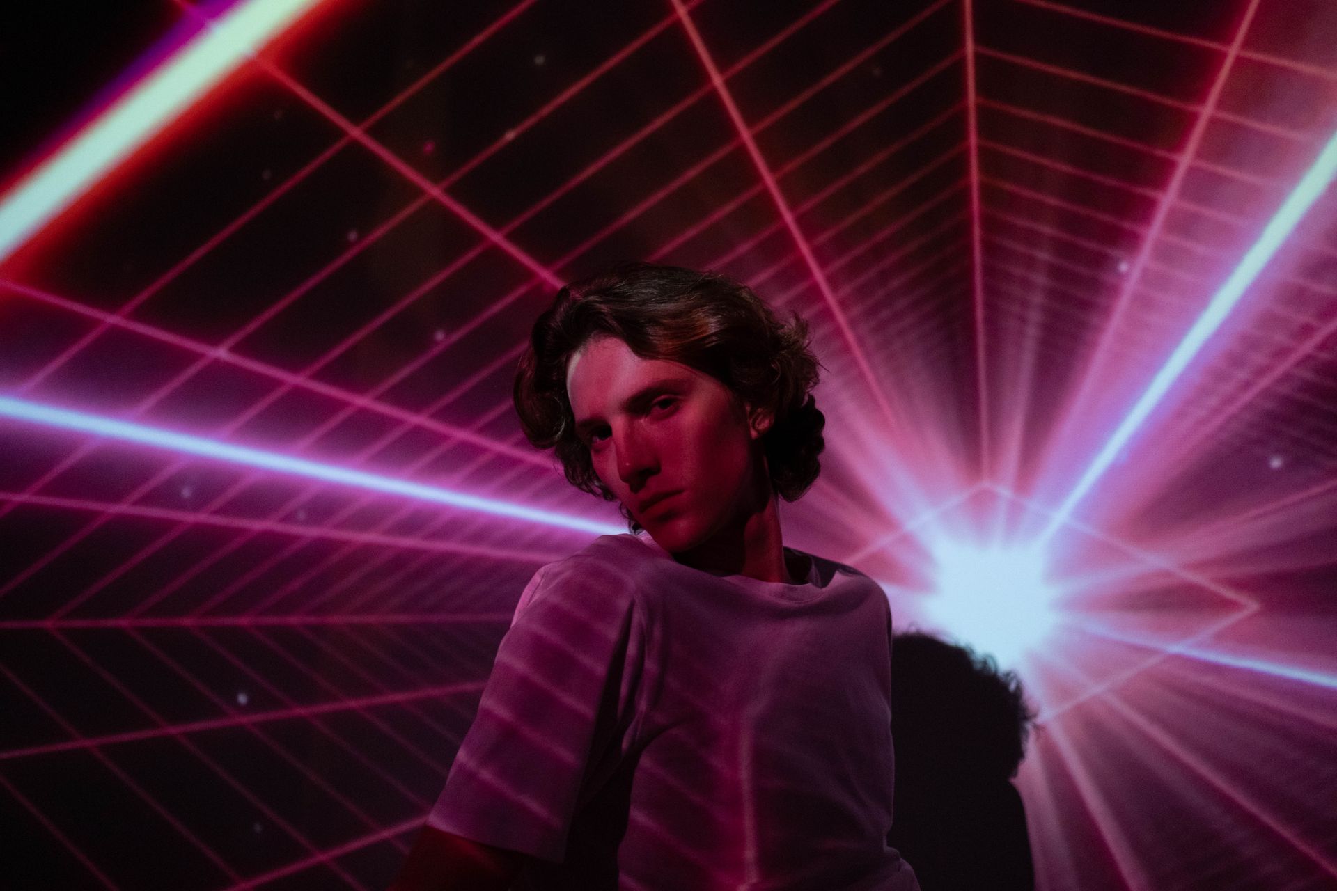 Dynamic studio portrait of a man with vibrant neon lights creating a futuristic atmosphere.