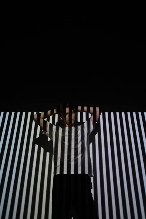 Person in Black and White Striped Wall