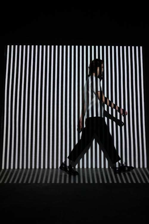 Man Walking on Stripe Wall