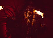 Man with Face Painting Holding a Torch