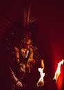 Man Wearing a Costume Dancing with Fire
