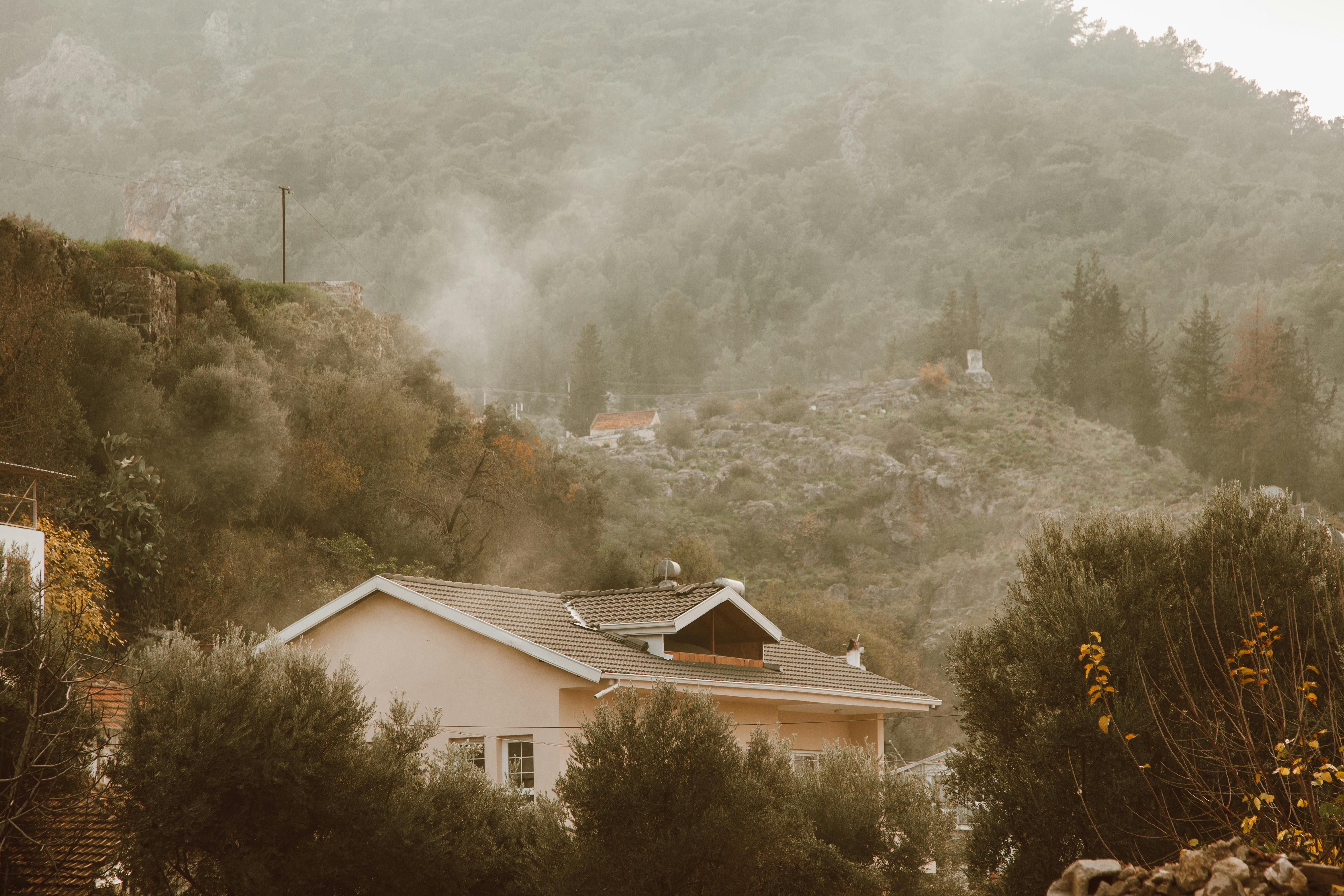 house with a tile roof near the mountains
