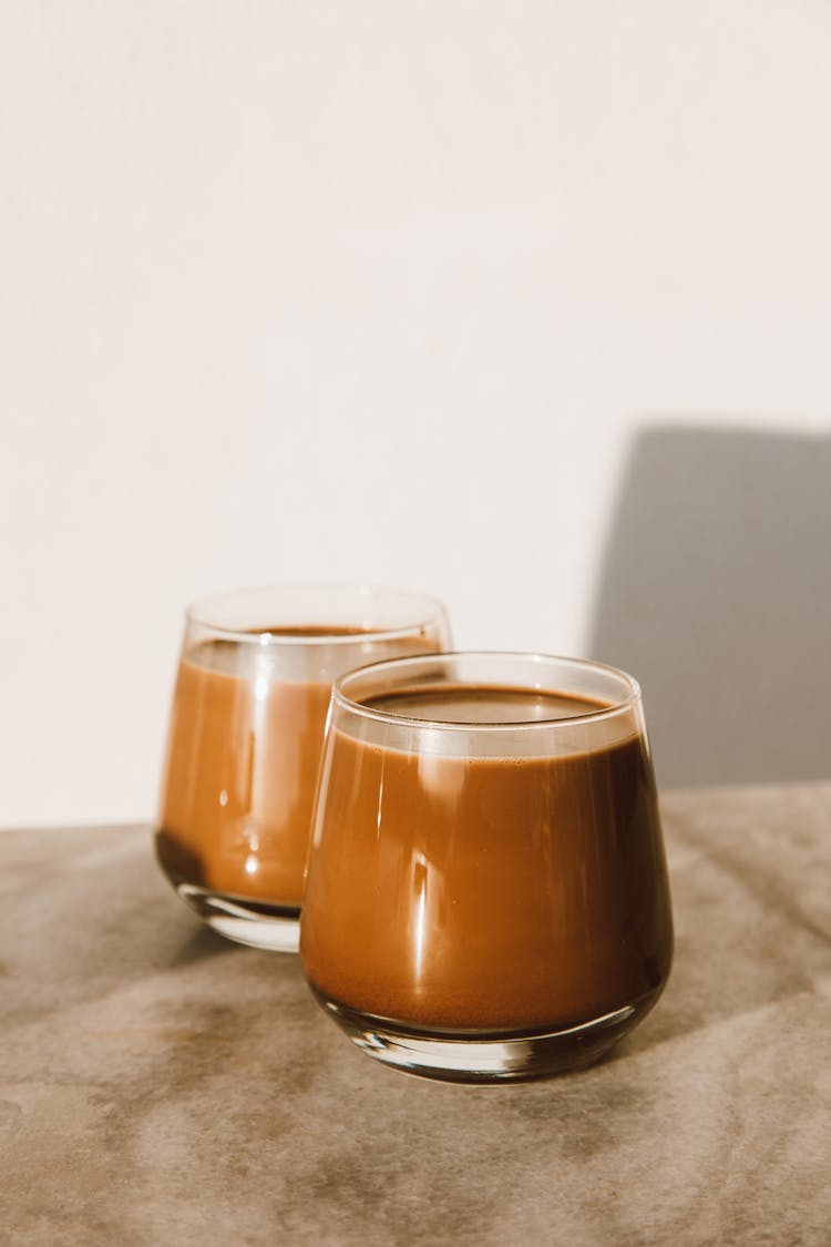 Two Clear Glasses Of Chocolate Drink