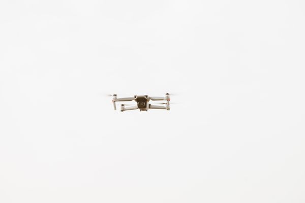 Small drone climbing against an overcast sky — photo by ROMAN ODINTSOV on Pexels