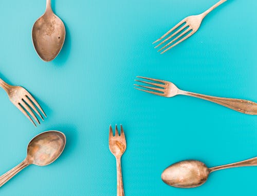 Set of old cutlery on blue background