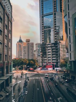 Dynamic view of a busy Shanghai intersection with modern skyscrapers at dusk.