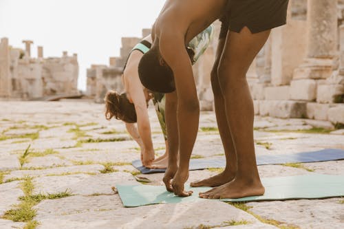 Free Man and Woman Doing Outdoor Yoga Stock Photo