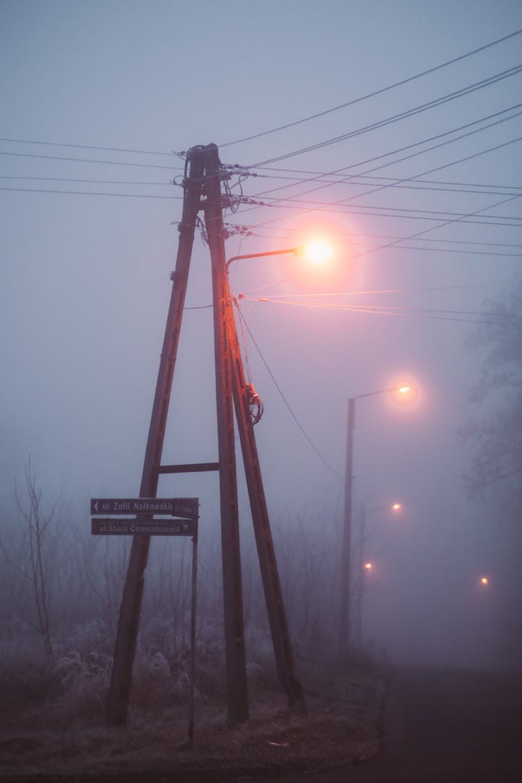 Electricity Pole By The Road Covered With Fog 