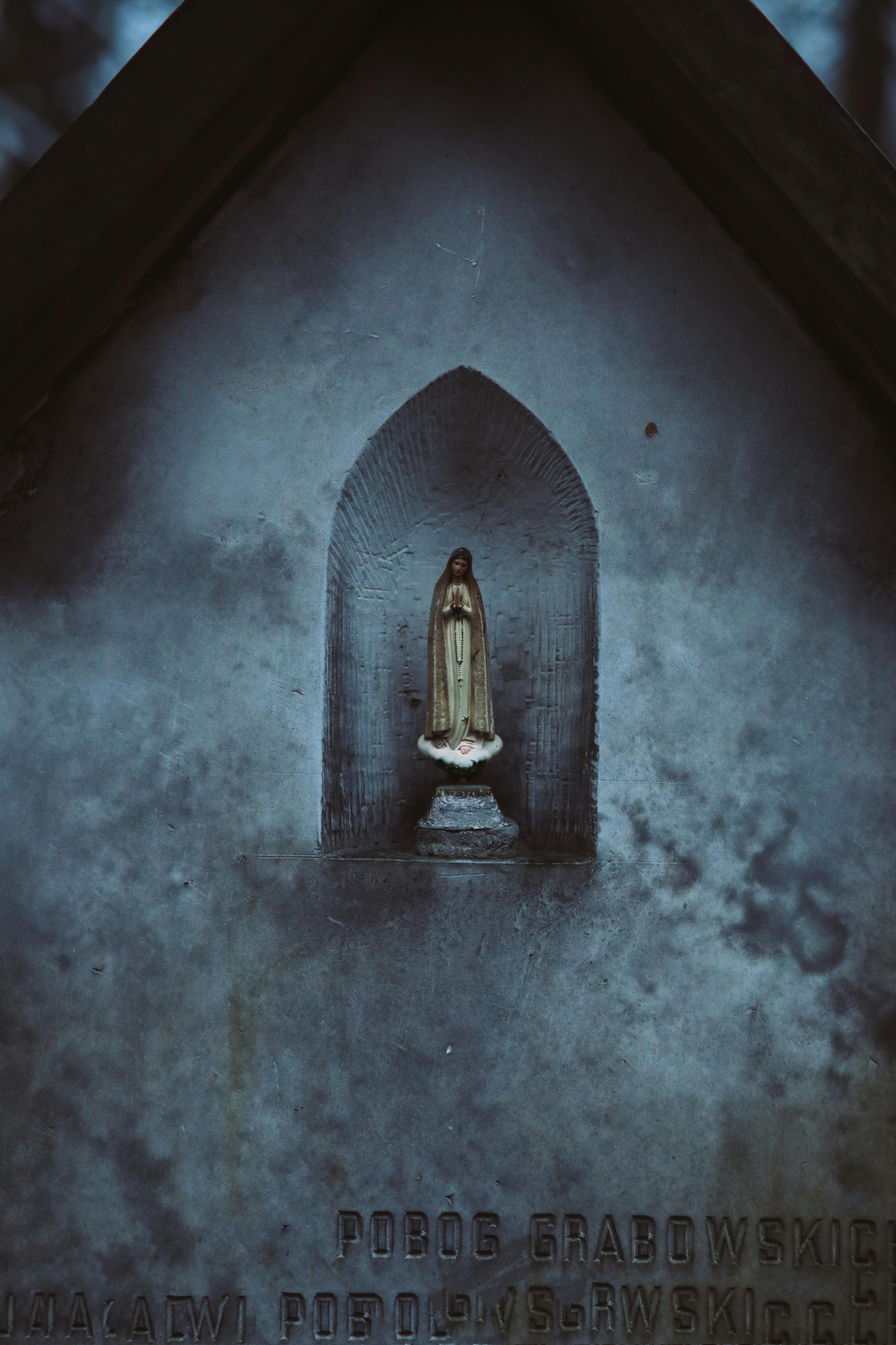 mary statue in a concrete wall