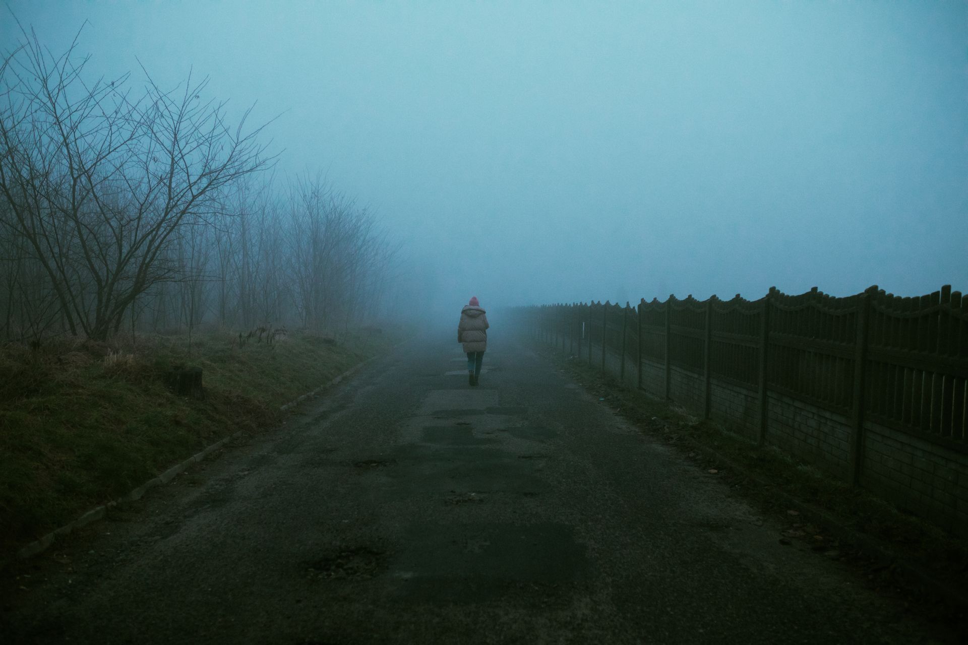 Person in Gray Jacket Walking on Pathway