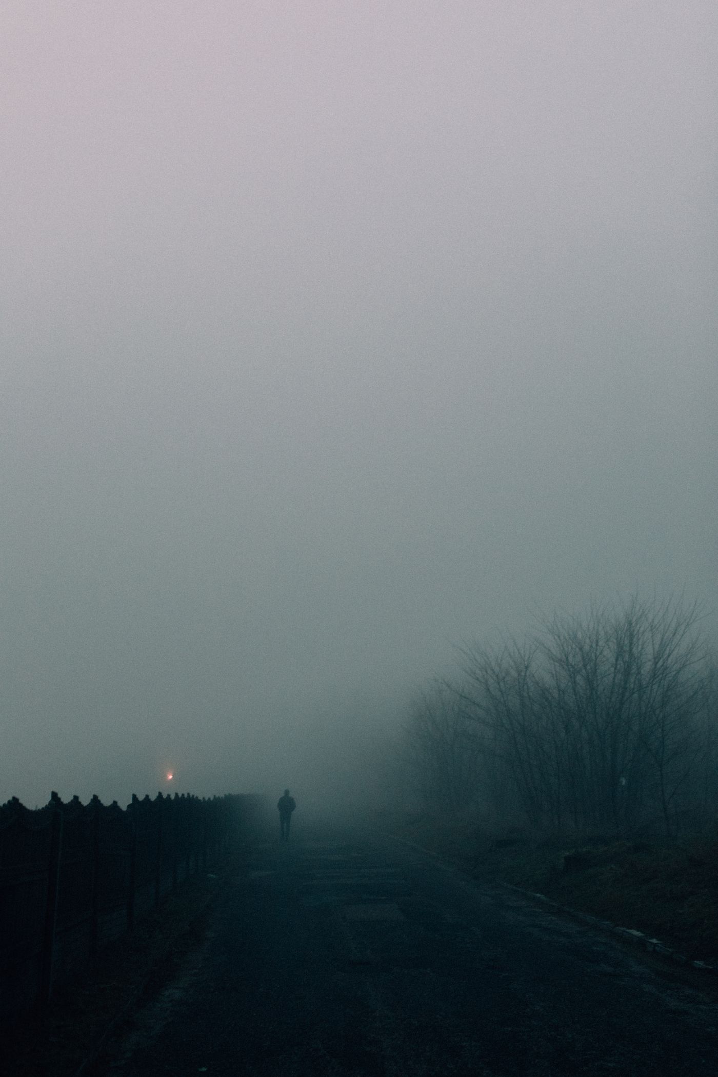 A lone traveler on a fog-covered road